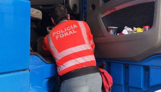 Un agente de la Policía Foral inspeccionando el camión,
