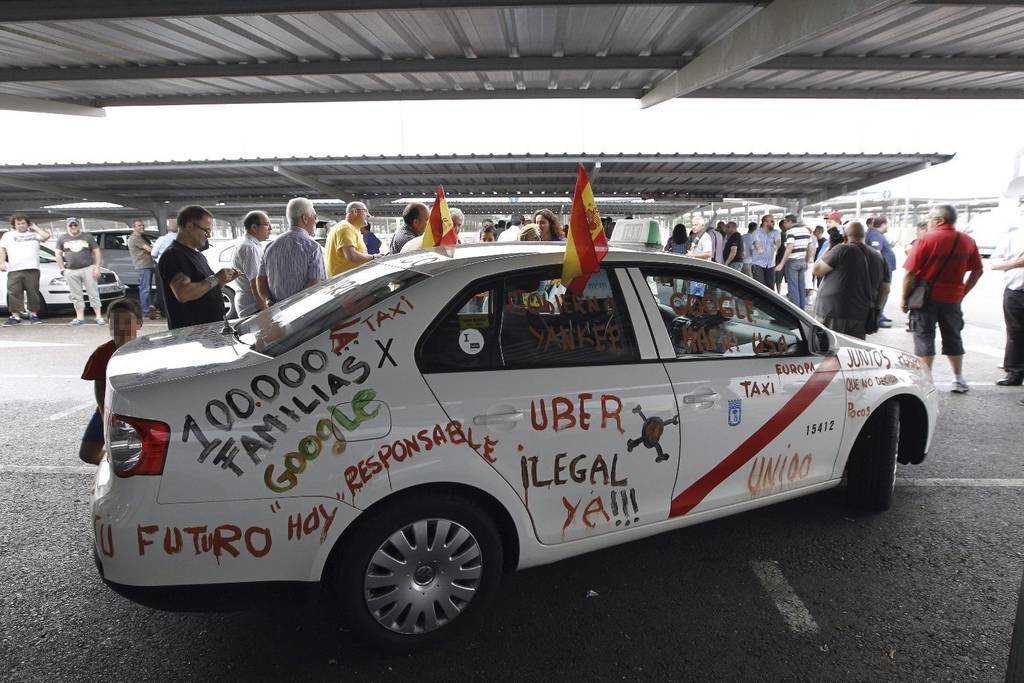 GRA399. MADRID, 11/06/2014.- Uno de los taxis que muestran con pintadas su descontento y que junto con centenares de taxistas de toda España han participado hoy en Madrid en la manifestación convocada por el sector, en coincidencia con las 24 horas de huelga de protesta por el intrusismo y la "ilegalidad" de aplicaciones de teléfonos móviles como Uber, convertidas en su principal competencia. EFE/ ALBERTO MARTIN