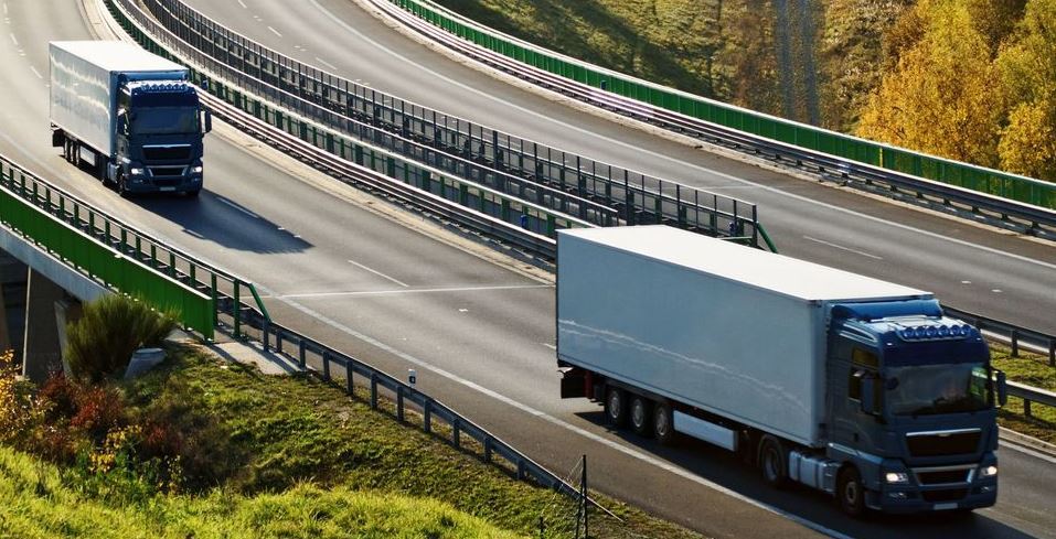Dos camiones circulando por una carretera