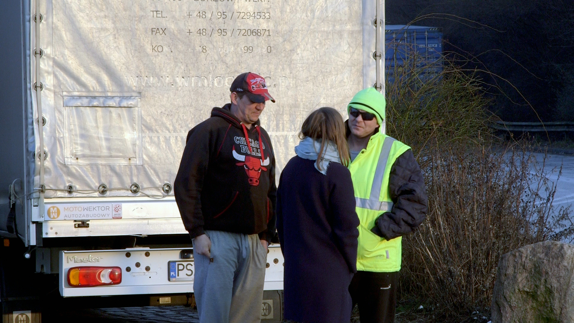 Tres personas están hablando en un estacionamiento. © NDR
